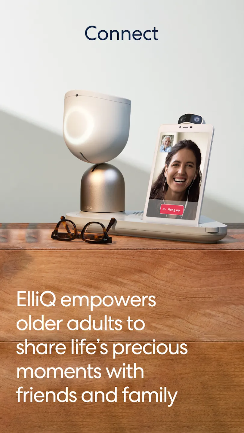 The ElliQ robot on a side table, screen lit, mid-interaction in a user's home